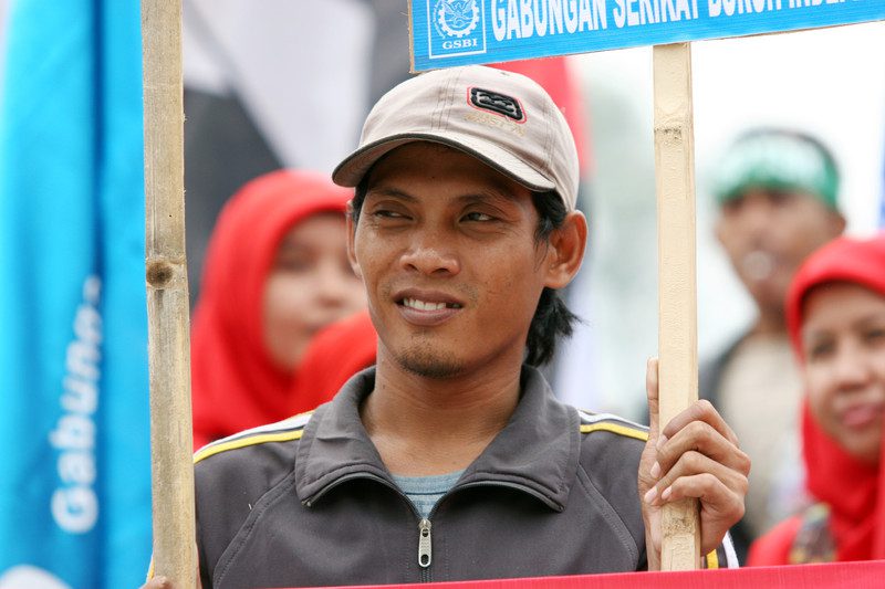 Workers demonstrate for fair labour conditions outside Hotel Indonesia in Jakarta. The protest is targeted at multinational brands that manufacture in Indonesia, including sportswear giants Nike, Puma and adidas. Photo: Rino Hidayah/OxfamAUS