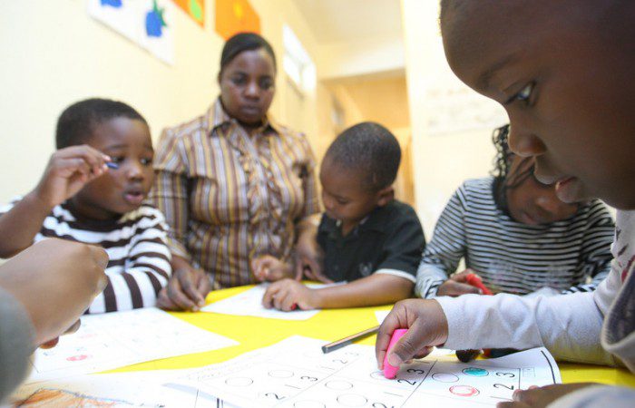 Kids absorbed in their colouring-in class at a home-based childcare centre, Durban. Photo: Gcina Ndwalane/OxfamAUS