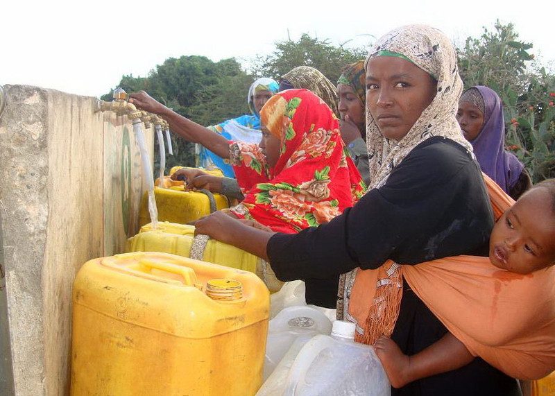 A woman collects water.