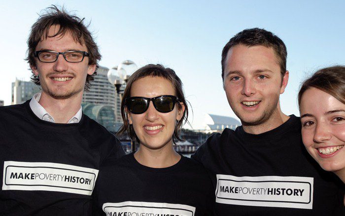 4 people smiling, wearing Make Poverty History Tshirts