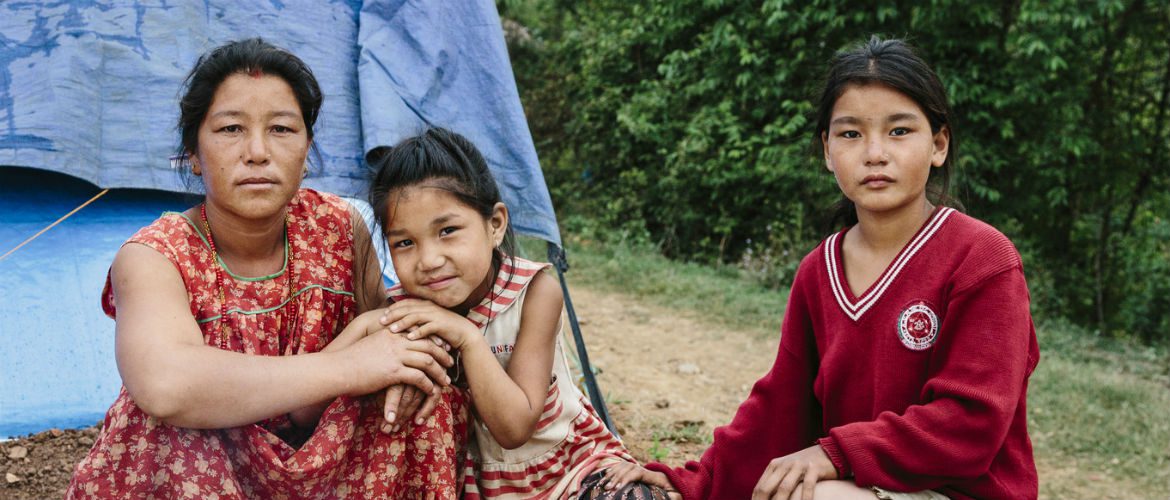Kavita stands with her two daughters outside their temporary shelter after the Nepal earthquake struck on 25 April 2015.