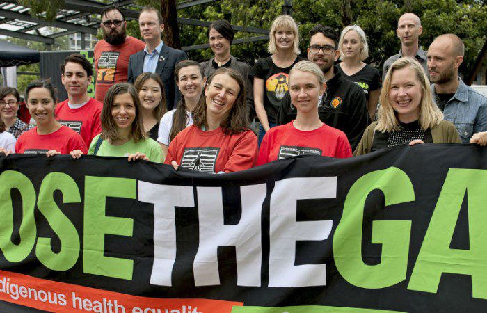 National Close the Gap participants hold a banner in support of Indigenous health equality