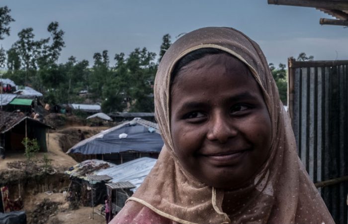 Nur*, 18 stands outside the Oxfam toilet that was installed near where she and her family have set up a home high on a hill in Balukali Camp, Bangladesh