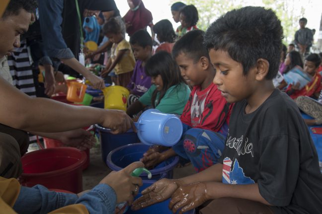 Children in Palu, Indonesia participate in hand washing demonstrations in the aftermath of September's earthquake and tsunami