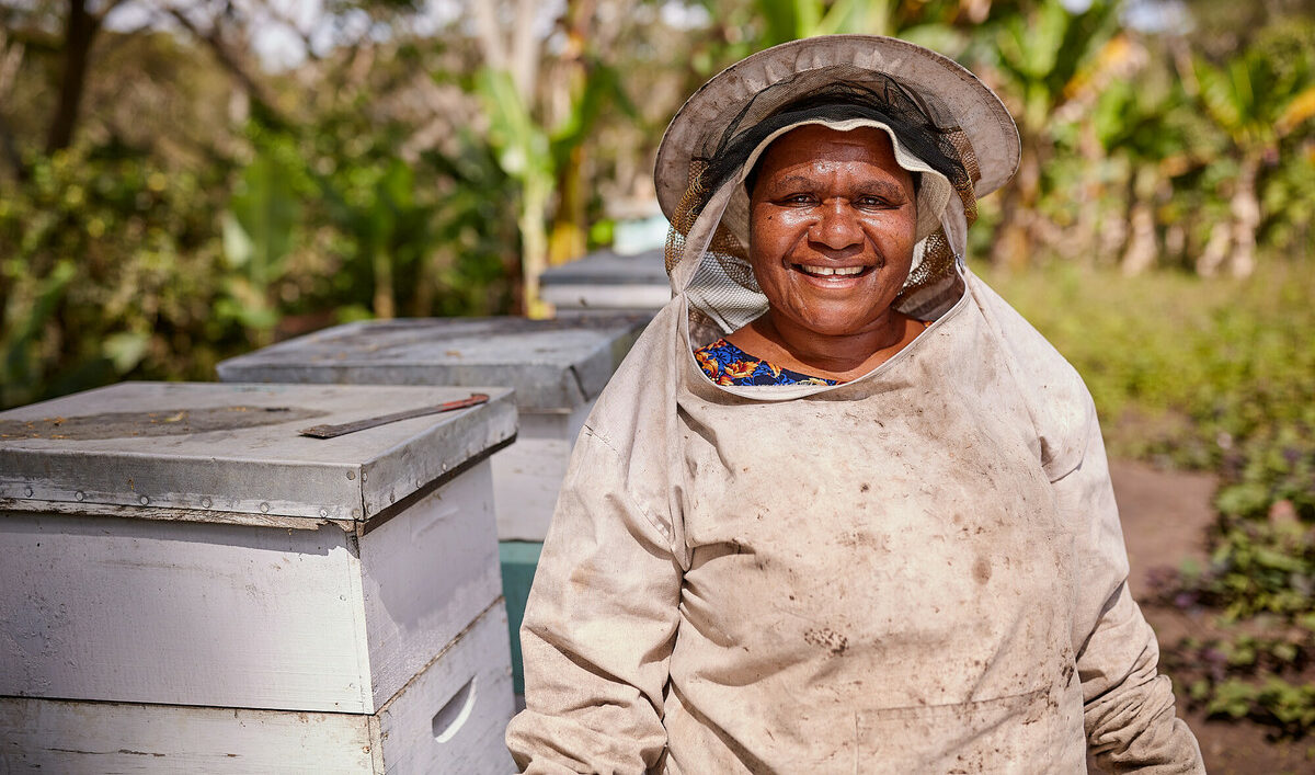 Eastern Highlands, Papua New Guinea: Onano Kapila prepares to collect honey from her hives in the Eastern Highlands. Photo: Patrick Moran/OxfamAUS